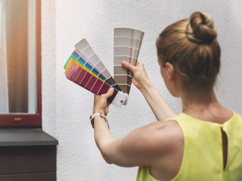 woman choosing paint color for house exterior facade